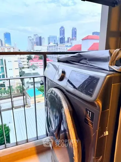 Modern washing machine on balcony with stunning city skyline view