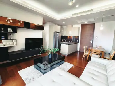 Modern open-layout living room with sleek kitchen and cozy dining area