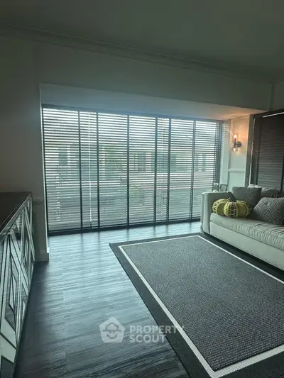 Stylish living room with floor-to-ceiling windows and modern decor