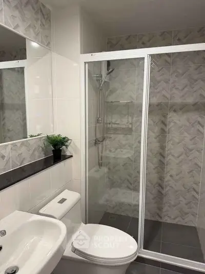 Modern bathroom with sleek shower and elegant tile design