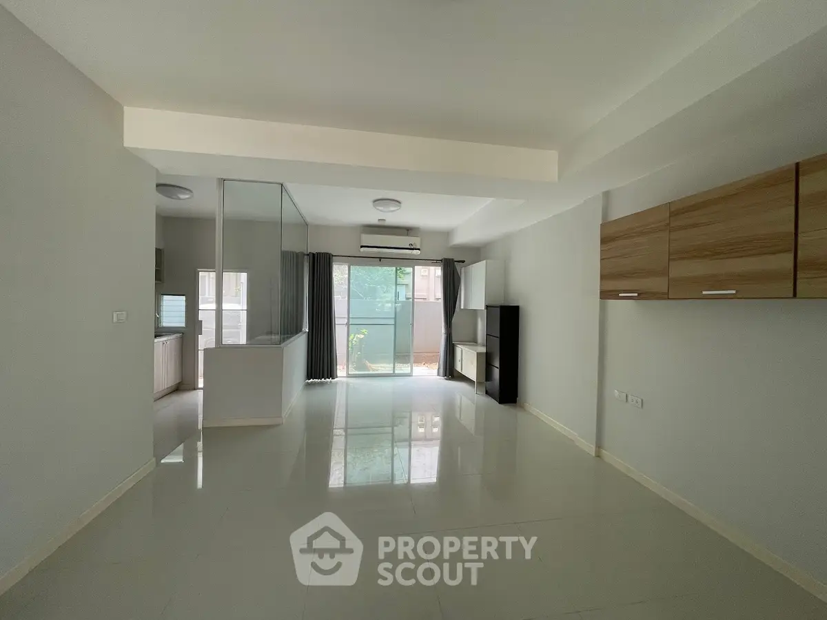 Spacious modern living room with open layout and large windows for natural light.