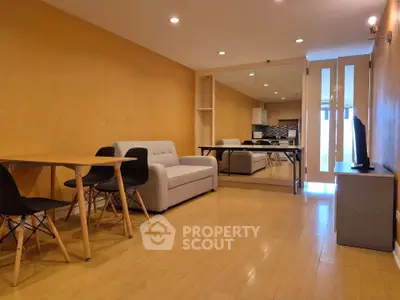 Modern living room with wooden flooring and stylish furniture in a cozy apartment.
