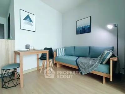 Modern living room with stylish furniture and decor, featuring a cozy sofa and dining area.