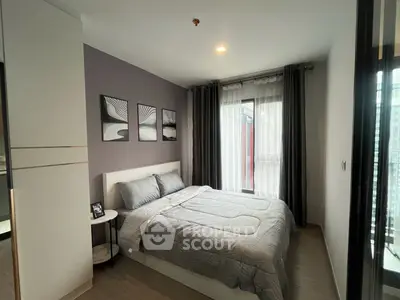 Modern bedroom with stylish decor and large window in urban apartment