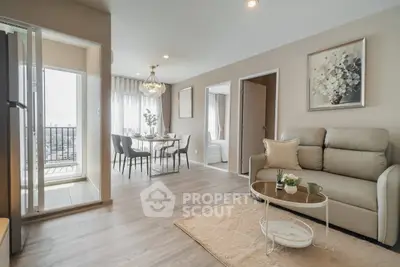 Modern living room with elegant decor and dining area, featuring a balcony with city view.