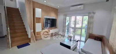 Modern living room with stylish decor and large windows for natural light