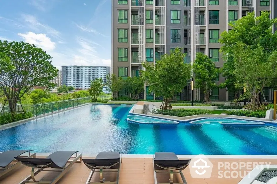 Luxurious condominium with stunning pool and lush garden view