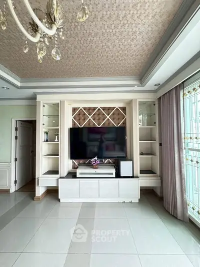 Luxurious living room with elegant ceiling design and built-in entertainment center