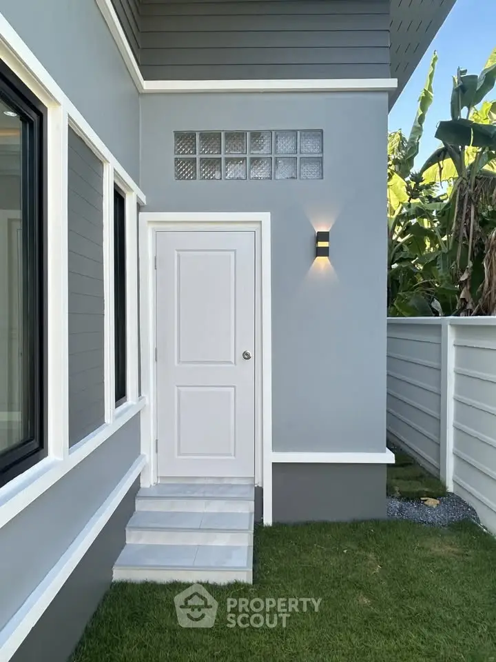 Modern exterior of a stylish home with sleek design and lush greenery, perfect for contemporary living.