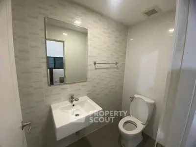 Modern bathroom with sleek fixtures and neutral tiles, perfect for a contemporary home.