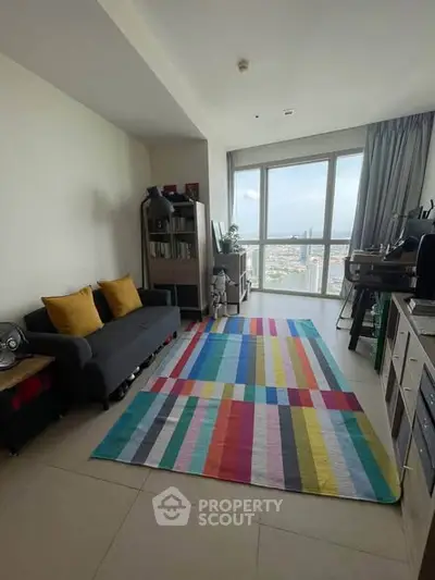 Modern living room with colorful rug and city view, perfect for urban living.