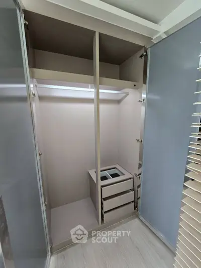 Spacious walk-in closet with modern design and ample storage space.