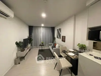 Modern living room with cozy seating and dining area, featuring stylish decor and natural lighting.