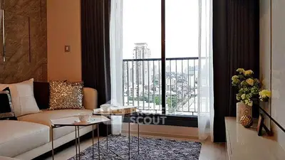 Modern living room with city view, elegant decor, and cozy seating area.