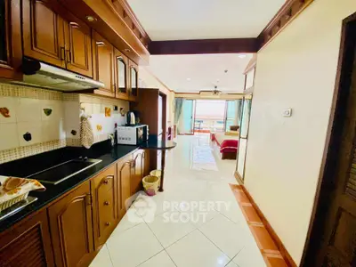 Spacious open-layout kitchen leading to a bright living area with modern amenities.