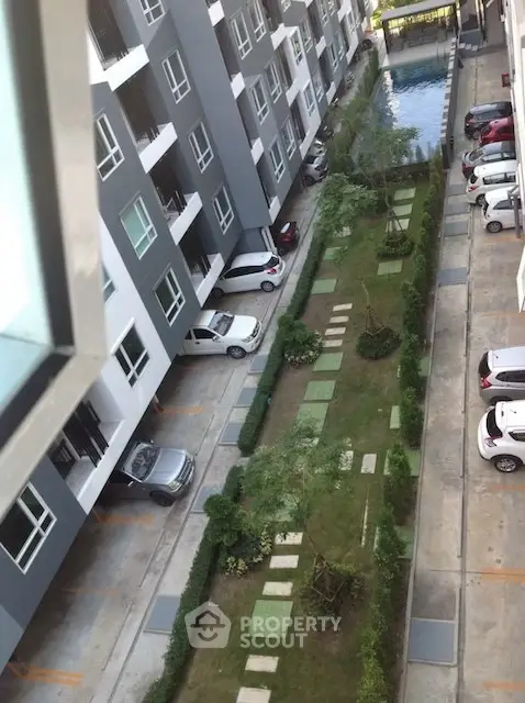 Modern apartment complex with pool and parking area view