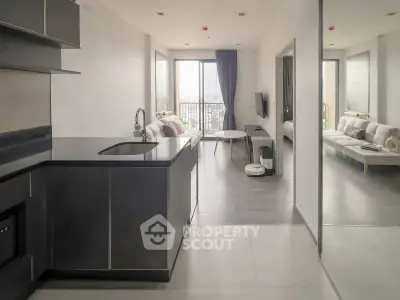 Modern open-layout kitchen and living room with city view balcony in stylish apartment.