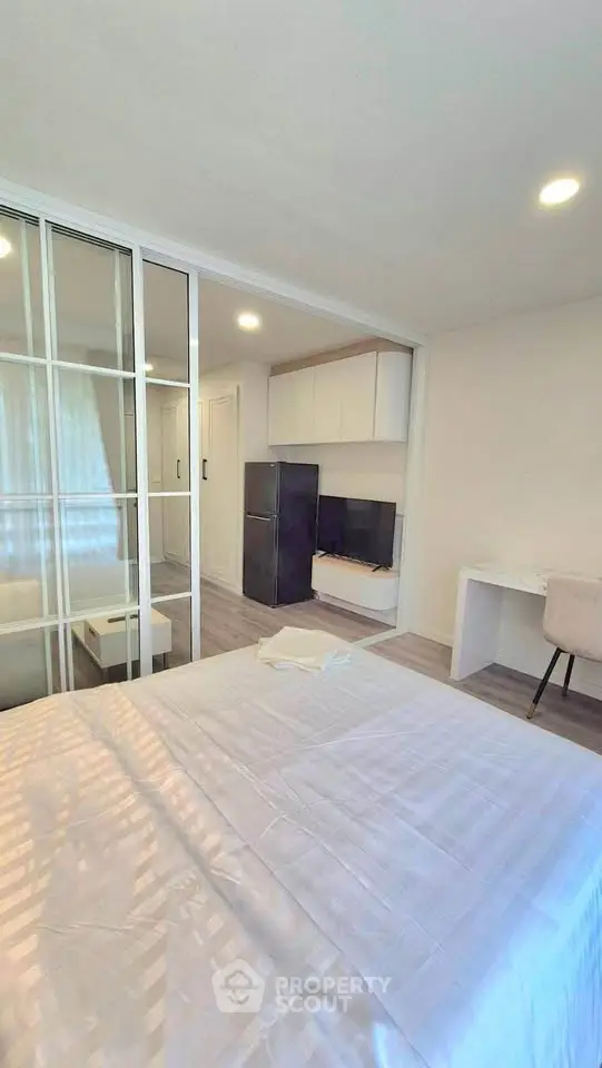 Modern bedroom with glass partition and sleek furniture design