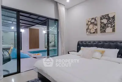Luxurious bedroom with pool view and elegant decor, perfect for relaxation and comfort.