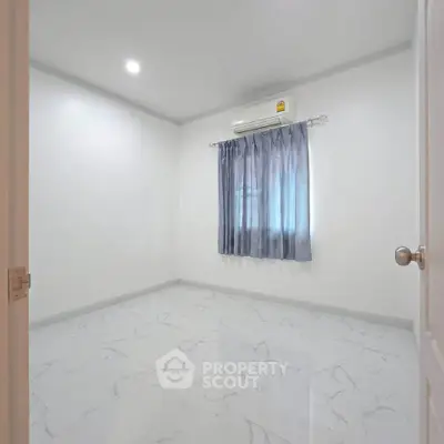 Spacious empty bedroom with marble flooring and air conditioning, ready for customization.