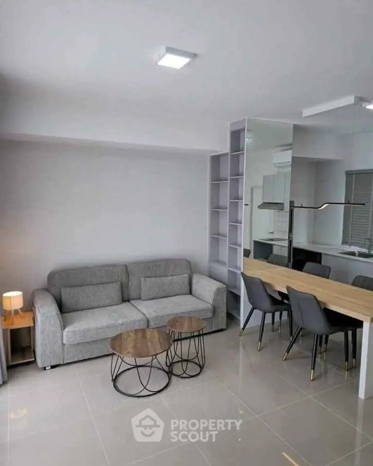 Modern living room with sleek furniture and open dining area, perfect for contemporary living.