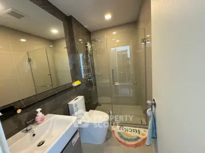 Modern bathroom with glass shower and sleek fixtures