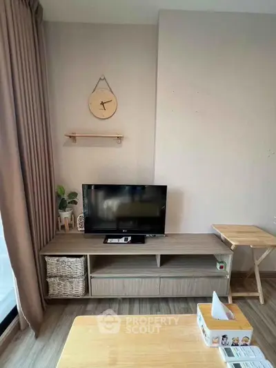 Modern living room with stylish TV stand and wooden furniture, perfect for cozy relaxation.