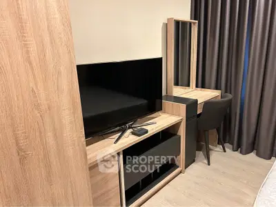 Modern bedroom with sleek wooden furniture and flat-screen TV, perfect for stylish living.