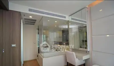 Modern bedroom with glass-enclosed bathroom and sleek furniture design