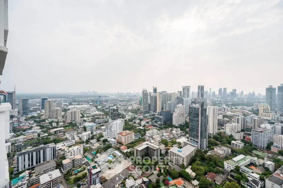 Stunning cityscape view from a high-rise building showcasing urban skyline and lush greenery.