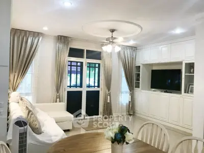 Elegant living room with white decor and cozy seating area