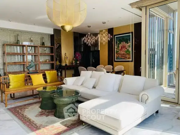 Luxurious living room with elegant decor and large windows offering abundant natural light.