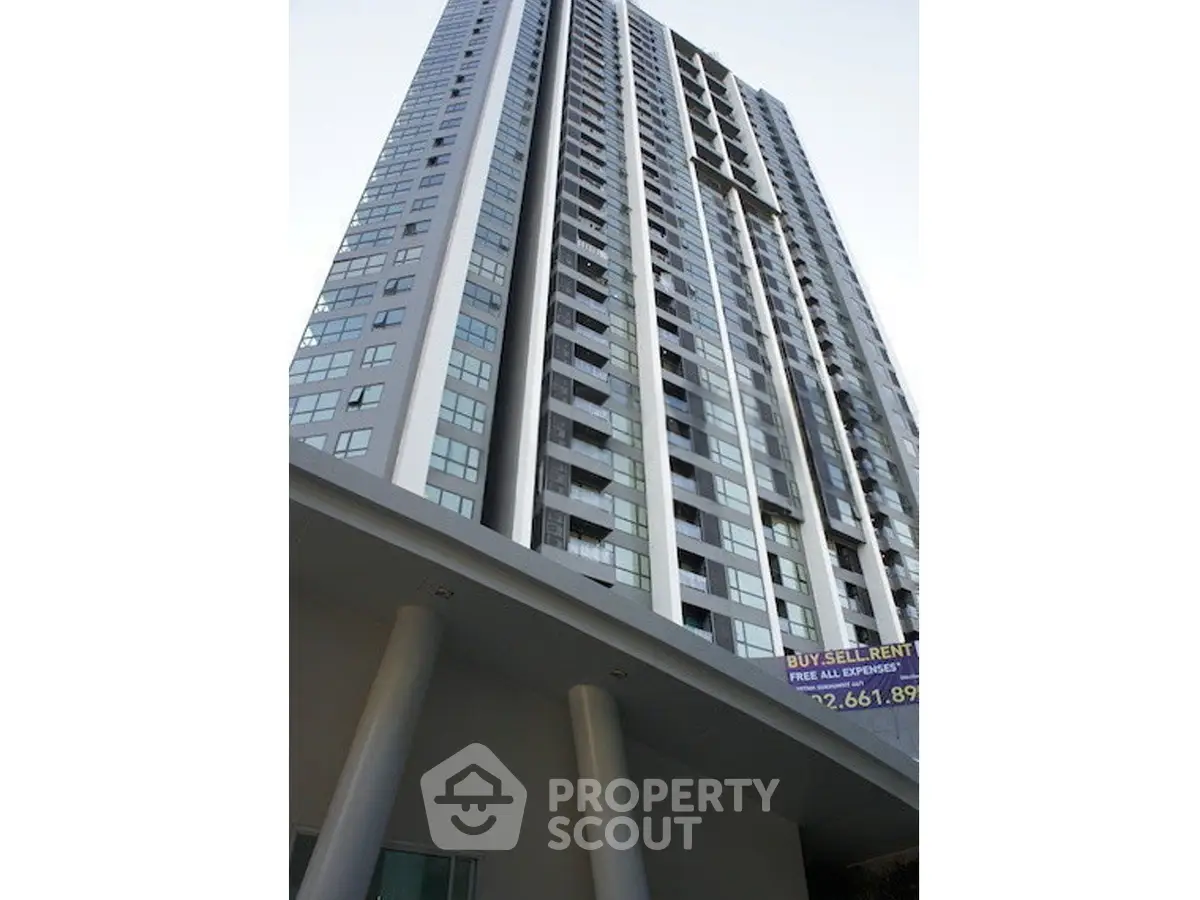 Modern high-rise building exterior with sleek design and large windows, ideal for urban living.