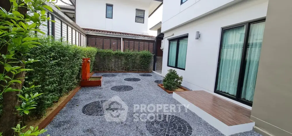 Charming modern garden with stone pathway and lush greenery