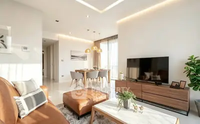 Modern living room with stylish furniture and natural light, featuring a cozy dining area and elegant decor.