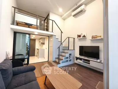 Modern loft apartment with mezzanine, stylish living room, and open kitchen layout.
