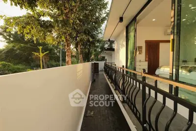 Modern balcony with sleek railing and lush greenery view