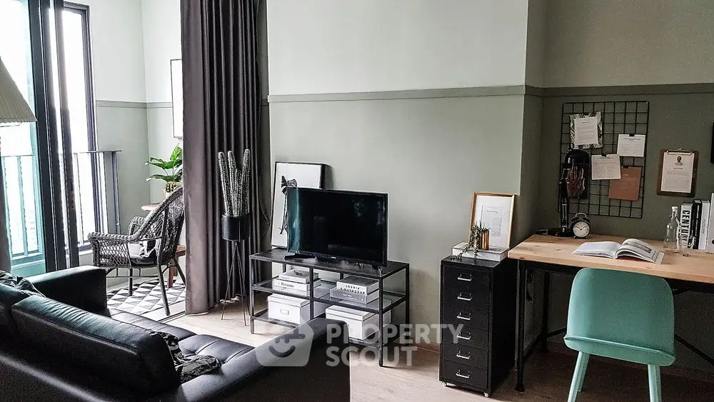 Stylish modern living room with TV, desk, and balcony access, perfect for urban living.