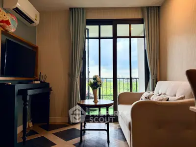 Charming living room with elegant decor and balcony view, perfect for relaxation and comfort.