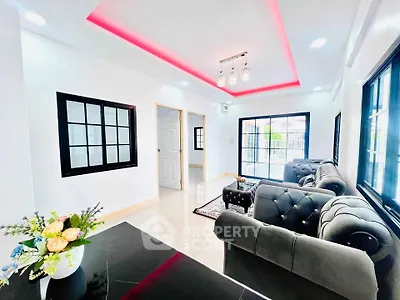 Modern living room with stylish sofas and vibrant ceiling lighting