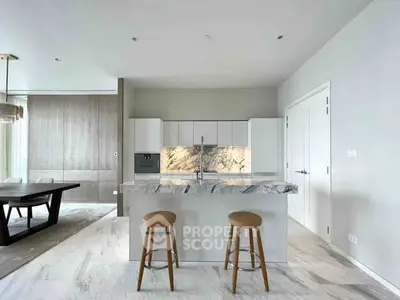 Luxurious modern kitchen with marble island and elegant dining area, perfect for entertaining.