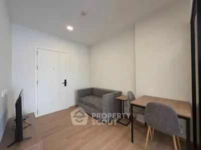 Modern minimalist living room with cozy gray sofa and wooden floor