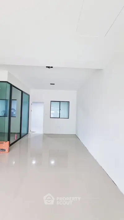 Spacious modern interior with glossy tiled floors and large windows