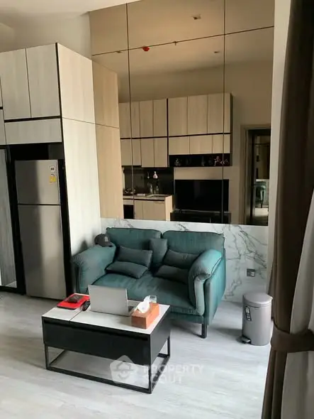 Modern living room with stylish sofa and open kitchen layout in a chic apartment.