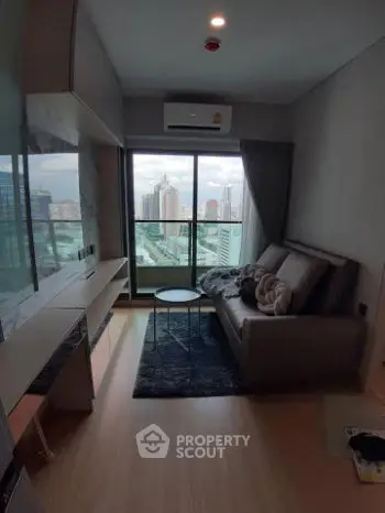 Modern living room with city view, featuring sleek furniture and large windows for natural light.