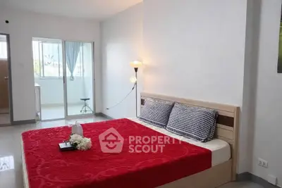 Spacious bedroom with modern decor and natural light, featuring a cozy bed and stylish furnishings.