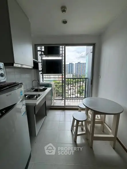 Modern kitchen with balcony view in urban apartment