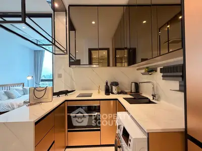Modern kitchen with sleek cabinetry and built-in appliances in a stylish apartment.