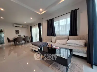 Modern living room with sleek furniture and elegant dining area