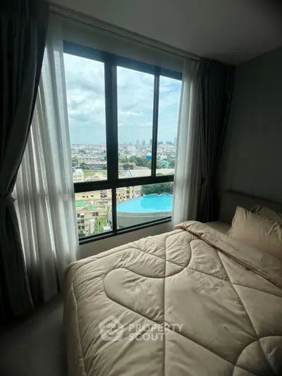Luxurious bedroom with stunning city view and pool from high-rise window.